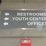 Interior Wayfinding sign with an Aluminum Panel between two Wooden Clamps for The Rock Church in Littleton, CO