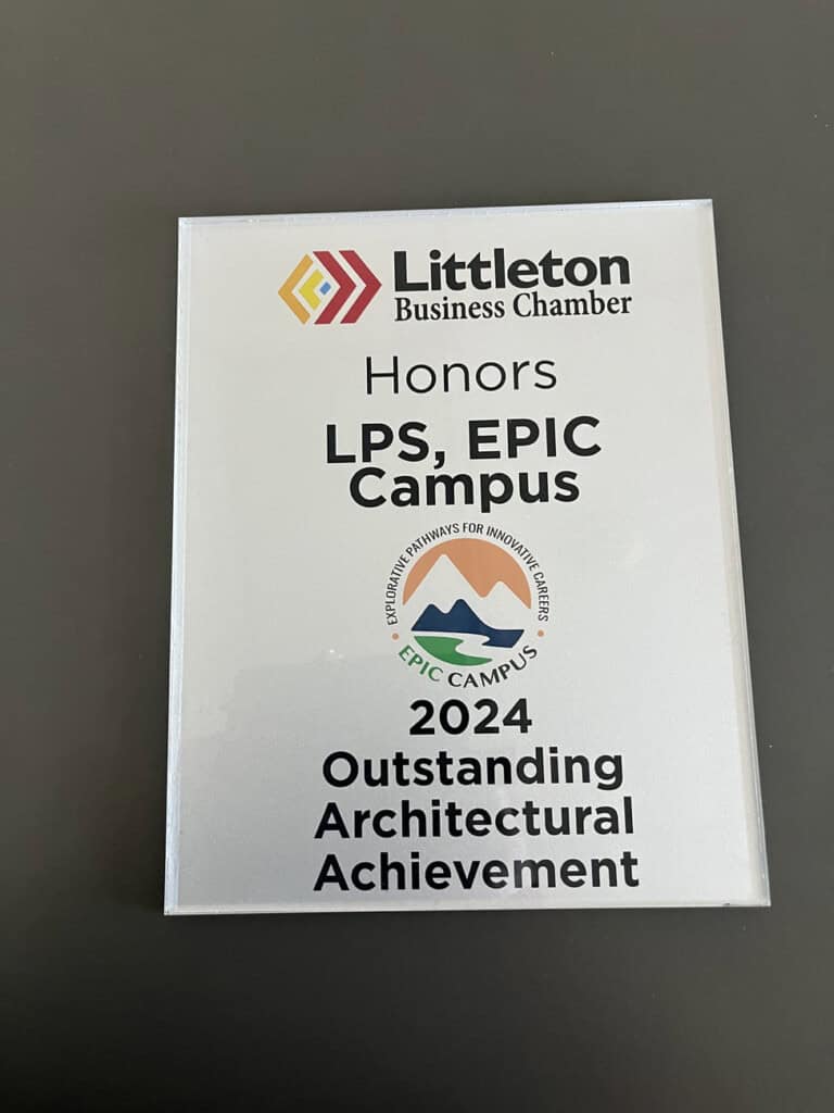 A plaque from the Littleton Business Chamber honors LPS, EPIC Campus with the 2024 Outstanding Architectural Achievement award. The plaque features the EPIC Campus logo with stylized mountains.